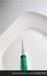 High angle view of a green syringe