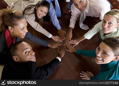 High angle view of a group of business executives with their hands on a table