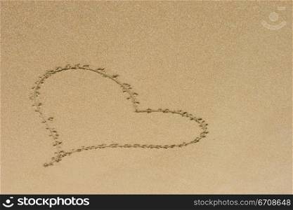 High angle view of a heart shape drawn on sand