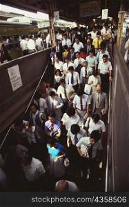 High angle view of a large group of people walking at a railroad station, Tokyo Prefecture, Japan