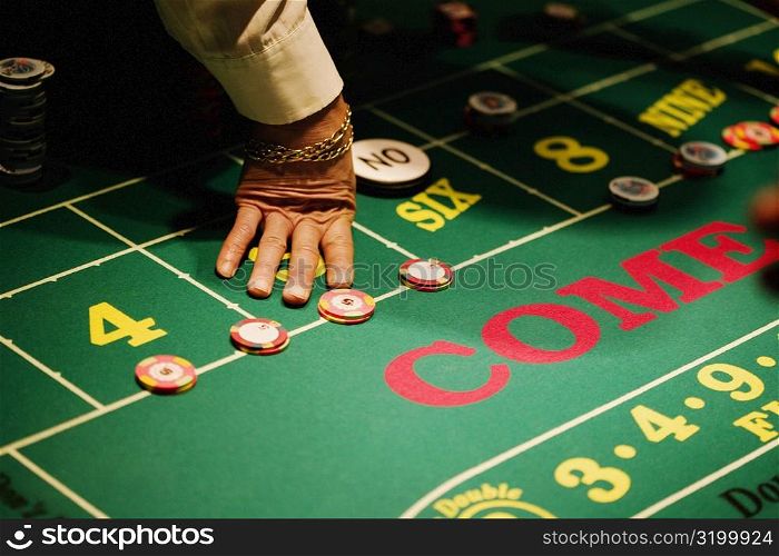 High angle view of a man&acute;s hand on a gaming table in a casino, Las Vegas, Nevada, USA