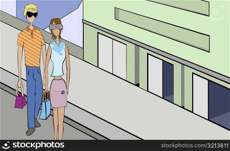 High angle view of a man and a woman carrying shopping bags