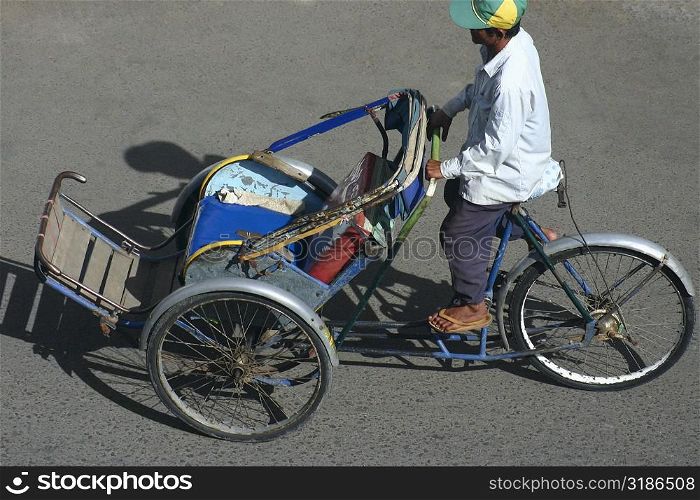 High angle view of a man riding a pedicab, Sihanoukville, Cambodia