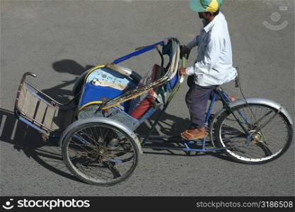 High angle view of a man riding a pedicab, Sihanoukville, Cambodia