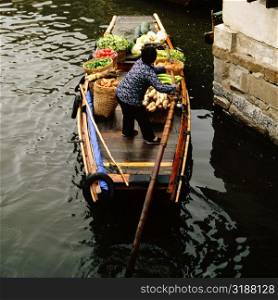 High angle view of a man rowing a rowboat in a canal, Zhouzhuang, Kunshan City, Jiangsu Province, China