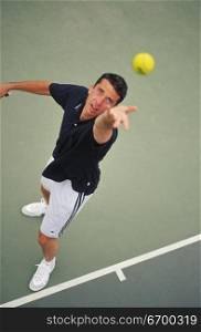 High angle view of a man serving at a tennis match