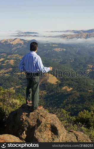 High angle view of a man standing on a hilltop