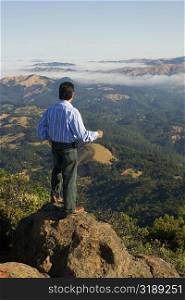 High angle view of a man standing on a hilltop