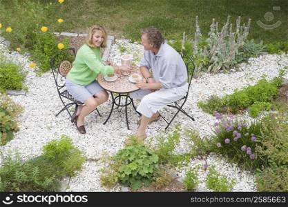 High angle view of a mature couple sitting at a table and drinking tea