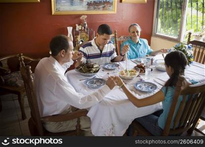 High angle view of a mature couple with their son and daughter at a dining table