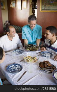 High angle view of a mature couple with their son and daughter sitting at a dining table