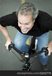 High angle view of a mature man cycling
