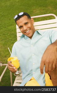 High angle view of a mature man holding a glass of juice