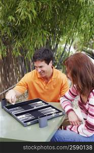High angle view of a mature woman and a mature man playing backgammon