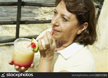 High angle view of a mature woman drinking juice