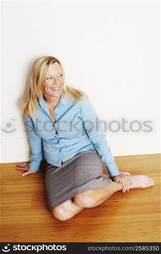 High angle view of a mature woman kneeling on the floor and smiling