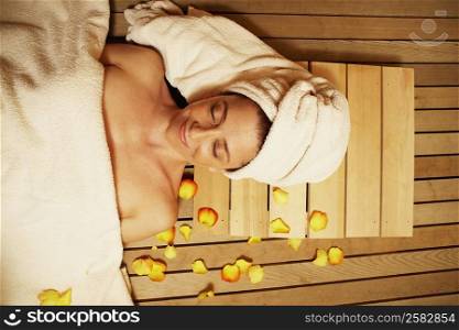 High angle view of a mature woman lying in a sauna