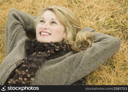 High angle view of a mature woman lying on grass
