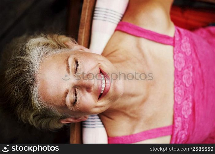 High angle view of a mature woman smiling with her eyes closed