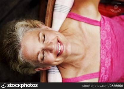 High angle view of a mature woman smiling with her eyes closed