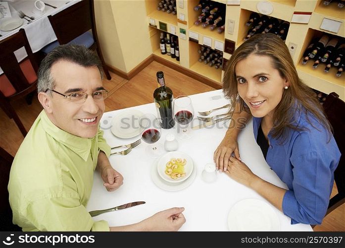 High angle view of a mid adult couple sitting at a table in a restaurant