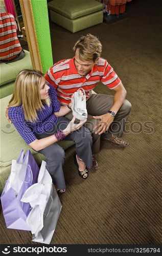 High angle view of a mid adult man and a young woman in a shoe store