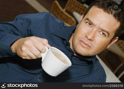 High angle view of a mid adult man drinking a cup of tea