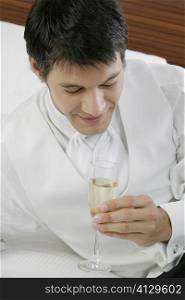High angle view of a mid adult man holding a champagne flute