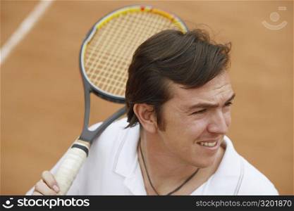 High angle view of a mid adult man holding a tennis racket on a tennis court