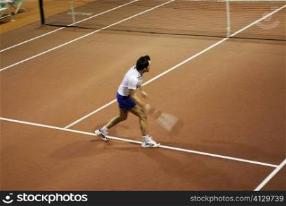 High angle view of a mid adult man playing tennis
