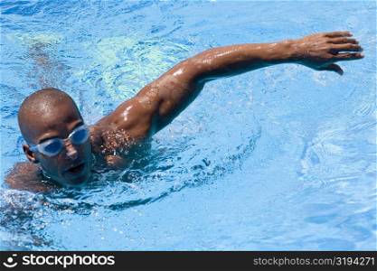 High angle view of a mid adult man swimming in a swimming pool