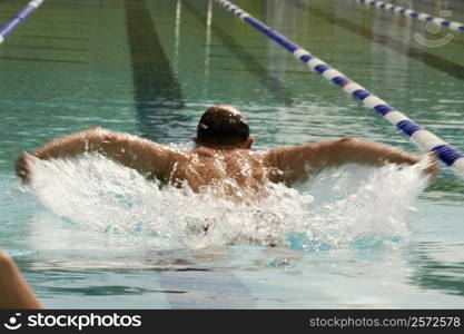 High angle view of a mid adult man swimming the butterfly stroke