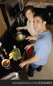 High angle view of a mid adult man with his mother in the kitchen