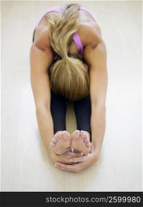 High angle view of a mid adult woman in a bend pose