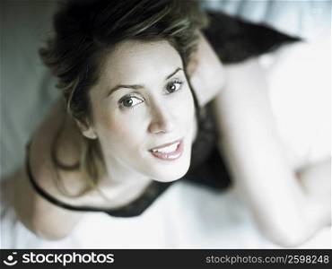 High angle view of a mid adult woman sitting on the bed