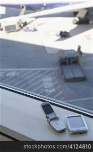 High angle view of a mobile phone and a personal data assistant