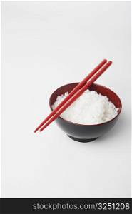 High angle view of a pair of chopsticks on a bowl of rice