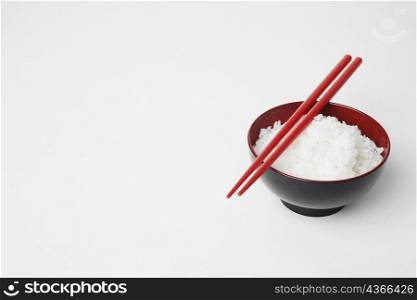 High angle view of a pair of chopsticks on a bowl of rice