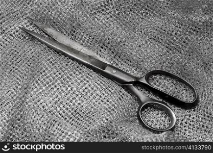 High angle view of a pair of scissors on fabric