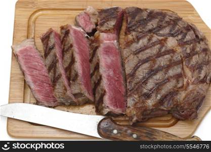 High angle view of a partly-sliced grilled wagyu beef ribeye steak viewed from above