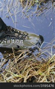 High angle view of a person&acute;s foot wearing wading boots