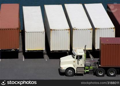 High angle view of a semi-truck with cargo containers at a commercial dock