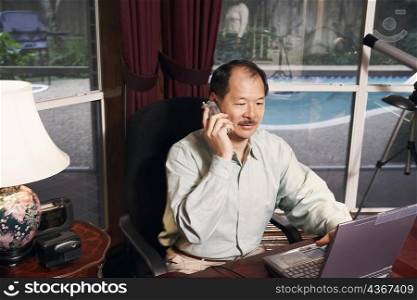 High angle view of a senior man talking on a cordless telephone