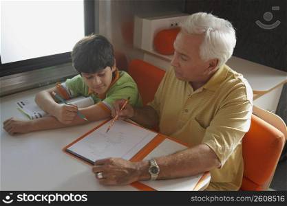 High angle view of a senior man teaching his grandson in a motor home