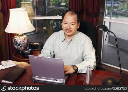 High angle view of a senior man using a laptop