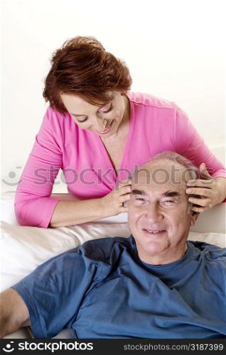 High angle view of a senior woman giving a senior man a head massage