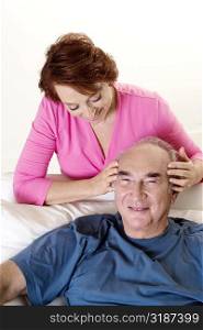 High angle view of a senior woman giving a senior man a head massage