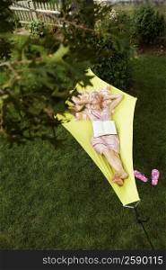 High angle view of a senior woman lying in a hammock