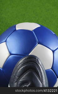 High angle view of a soccer shoe and a soccer ball