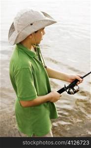 High angle view of a teenage boy fishing in a lake